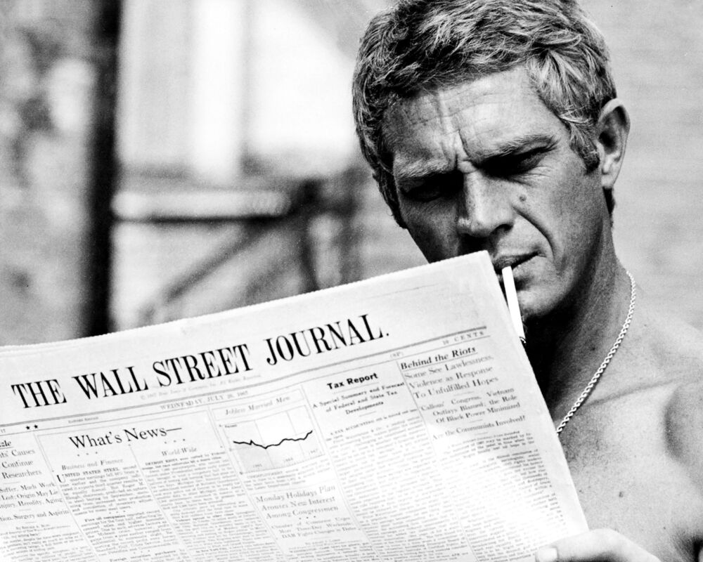 Portrait of Steve McQueen reading the wall street journal, 1967