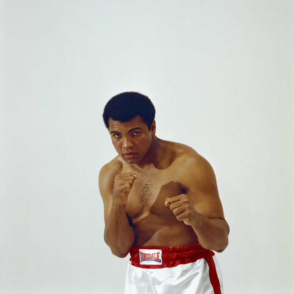 LOWELL RILEY MUHAMMAD ALI SHOWING HIS FISTS DOMINANT WHITE